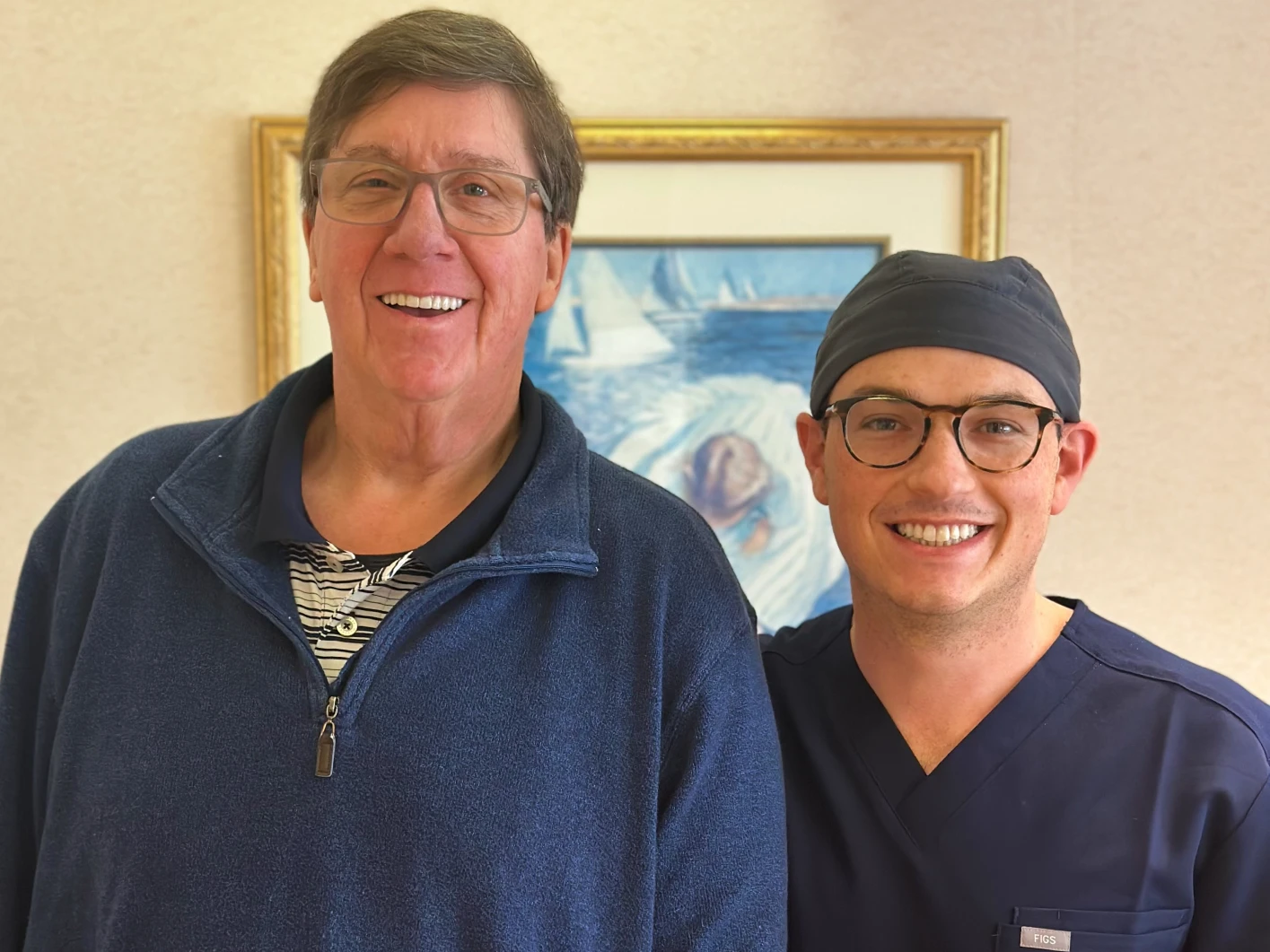 Dr. Gordon smiling with a patient after full mouth dental implants.